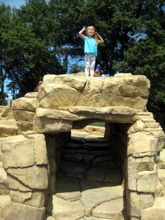 Child on rock structure at Discovery Hollow, Tamarack Nature Center