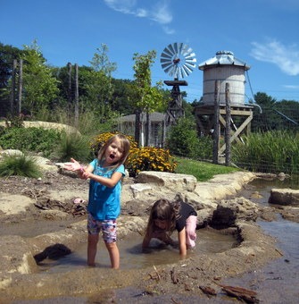 Kids playing in muddy stream at Discovery Hollow, Tamarack Nature Cente