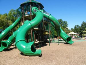 Large play structure with three tornado slides at Elm Creek Play Area