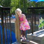 Girl in pink dress playing at Elm Creek Play Area