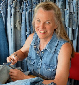 Author Debra Frasier among a pile of blue jeans