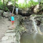 Girl by the Hidden Falls Park waterfall in Saint Paul, Minnesota