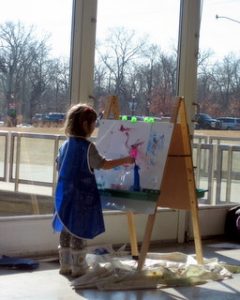 Child painting during a Lil' Explorer Thursday at Como Zoo in Saint Paul, Minnesota