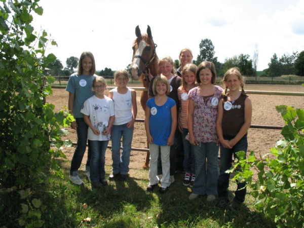Children standing with horse at Golden Ridge Stables in Lakeville