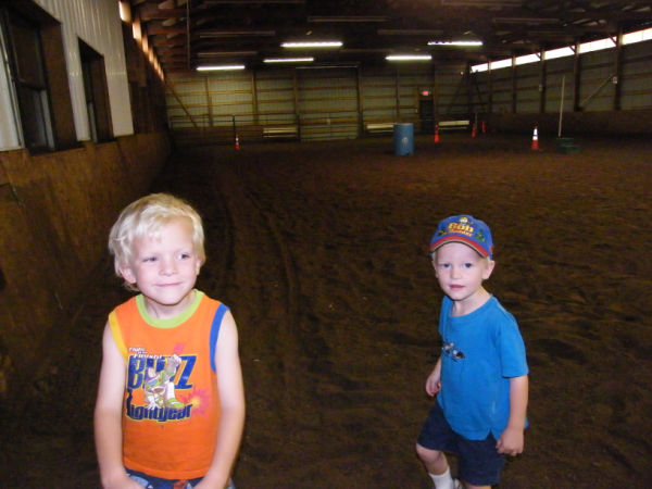Two boys in a barn at Bunker Park Stables in Andover Minnesota