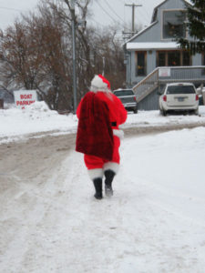 Santa walking away down the road in Stillwater, Minnesota