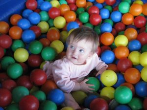 Toddler girl in ball pit at Eagles Nest Indoor Playground in New Brighton Minnesota