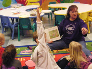 Theatre Arts Training instructor reading to a group of kids at Children's Theatre Company