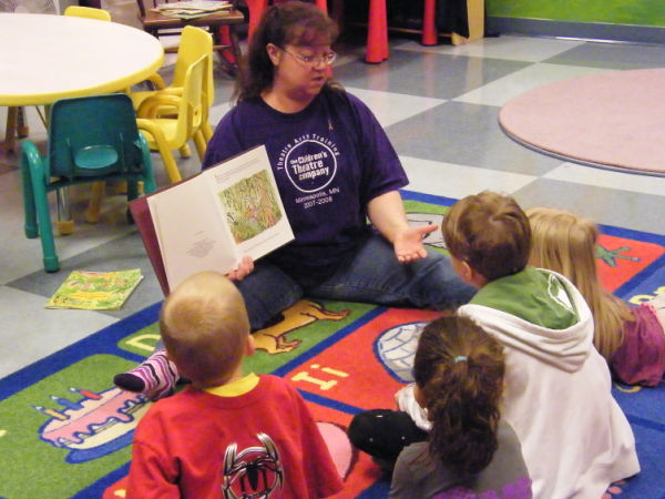 Instructor leading Theatre Arts Training (TATS) reading to a group of children at Children's Theatre Company in Minneapolis Minnesota