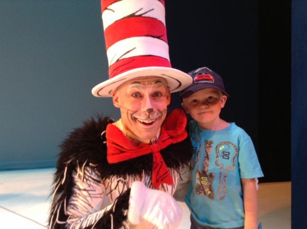 Actor Dean Holt posing with a little boy after a performance of The Cat in the Hat at Children's Theatre Company in Minneapolis, MN
