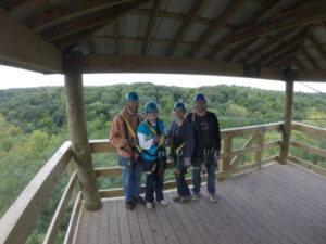 Two couples posing at the top of a zipline tower at Kerfoot Canopy Tours