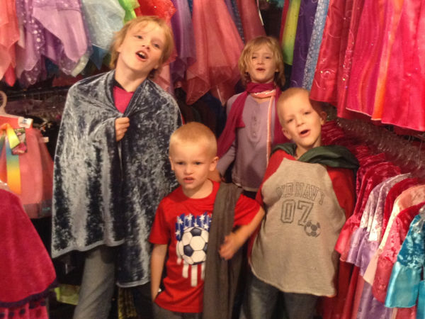 Four kids playing dress up at Fairy Finery