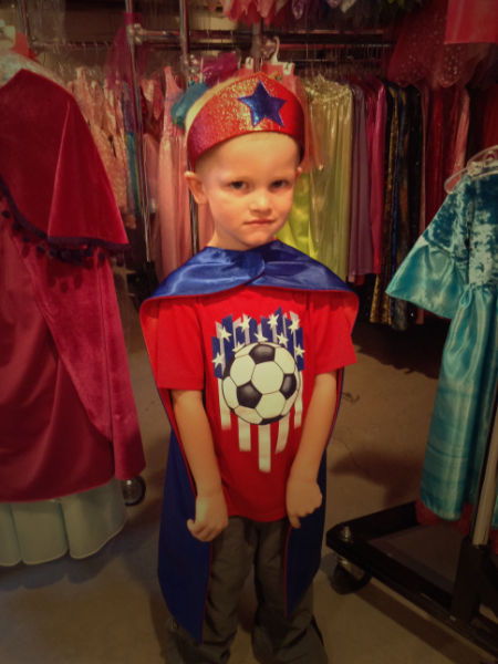 Boy dressed in crown and cape at Fairy Finery