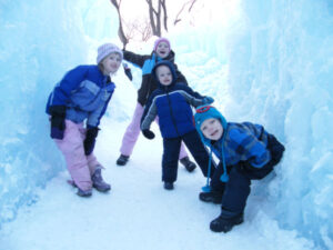 Four kids exploring Ice Castles in Eden Prairie, Minnesota in 2015