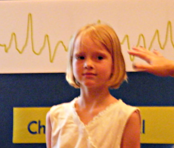 Young girl participating in a demonstration at the Bakken Museum in Minneapolis, Minnesota