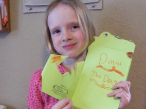 Girl showing the Dragon Book she created at Minnesota Center for Book Art in Minneapolis, MN
