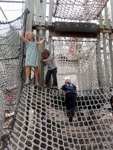 Kids playing on netting of the playground at French Regional Park in Plymouth, Minnesota