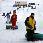 Kids climbing the tubing hill at Theodore Wirth Park in Minneapolis, MN