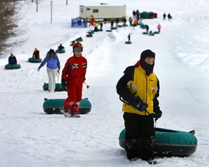 Kids climbing the tubing hill at Theodore Wirth Park in Minneapolis, MN