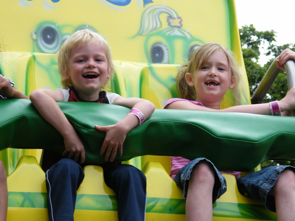 Two children giggling on the Frog Hopper ride when Family Fun Twin Cities visited Como Town Amusement Park in Saint Paul Minnesota