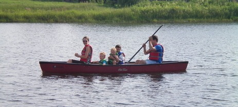 Family canoeing at Lakeside Commons Park in Blaine, inthe Twin Cities Northwest Metro