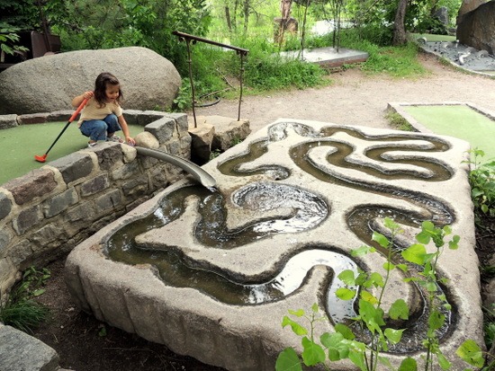 Girl admiring sculpture at Big Stone Mini Golf and Sculpture Garden in Minnesota