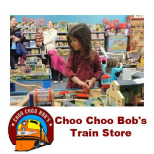 Young girl playing with a train display at Choo Choo Bob's Train Store in Minnesota