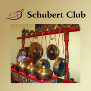 Girl playing with percussion instruments at Schubert Club Museum