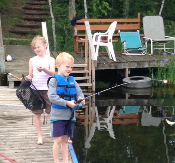 Two kids fishing from a dock