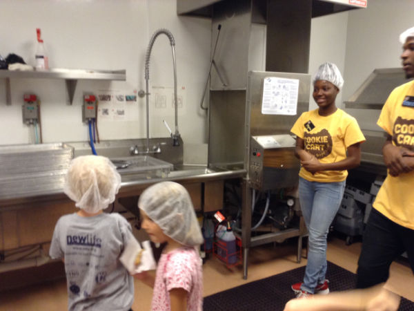 Kids taste testing cookies after a tour of the Cooke Cart in Minneapolis, Minnesota