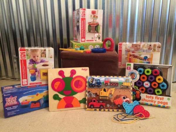Minneapolis Toy Library Toddler Toys, including puzzles, lacing cards, Tots First Chunky Pegs, Primary Bucket Balance and Shape Sorter