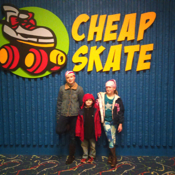 Three kids at Cheap Skate Roller Rink in Coon Rapids