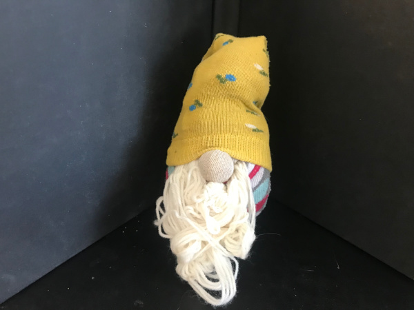 Sock gnome with a yellow hat and white beard.