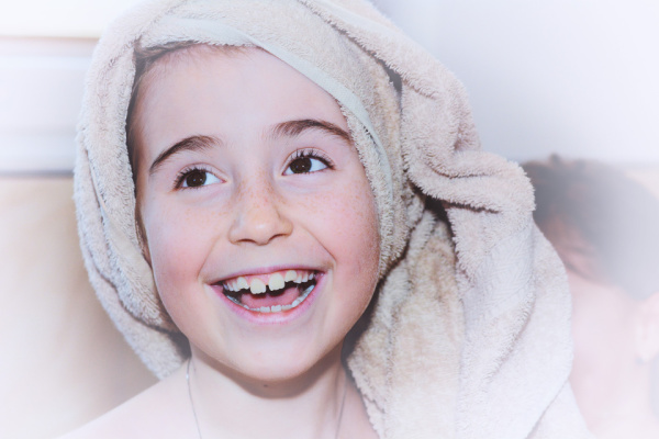 Girl wearing spa towel and laughing