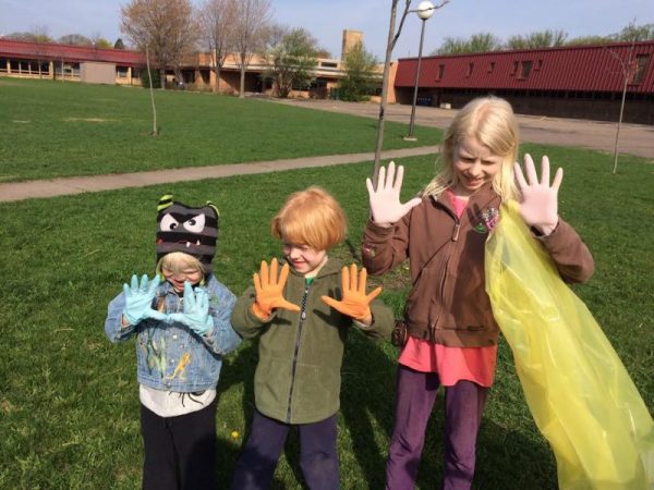 Earth Day Family Events - 3 kids showing clean up gloves at a park clean up event at Waite Park in Minneapolis, MN