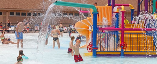 Kids playing in splash fountain Edina Aquatic Center