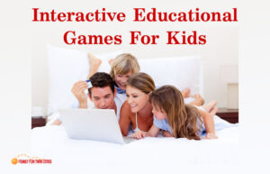 Interactive Educational Games For Kids. Family cuddled on a bed playing games on a laptop computer.