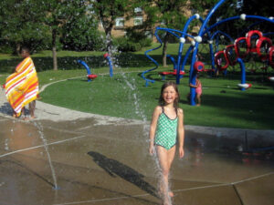 Girl playing in splash pad at Roy Wilkins Park in Saint Paul, MN
