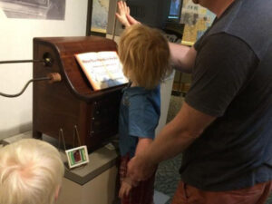 Family experimenting with the Theremin at the Bakken Museum in Minneapolis, Minnesota