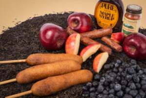 Minnesota State Fair corn dogs shown with flavor options - apple, sausage, blueberry, maple syrup, hot pepper