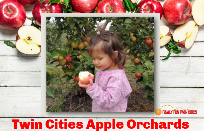 Small girl eating an apple next to an apple tree: "Twin Cities Apple Orchards" Background: apples on a white cutting board.
