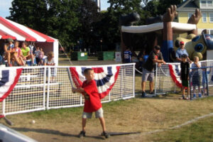 Boy batting in the Twins Experience attraction at the Minnesota State Fair