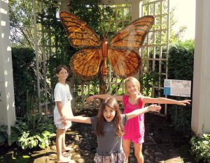 Three girls in front of Butterfly sculpture at the Minnesota Landscape Arboretum in Chaska, Minnesota