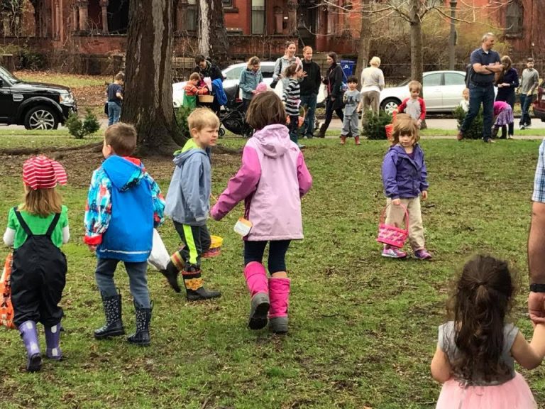 Kids participating in an outdoor Egg Hunt on the lawn of the Germanic American Institute in St. Paul, Minnesota