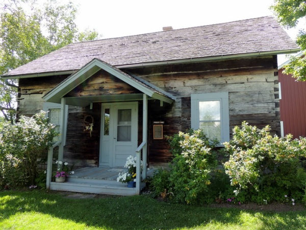 Front porch and exterior of preserved building of early Swedish immigrants found on the grounds of Gammelgården of Scandia Minnesota.
