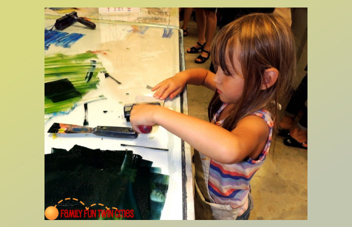 Girl trying out printmaking during a Free Ink Day at Highpoint Center for Printmaking