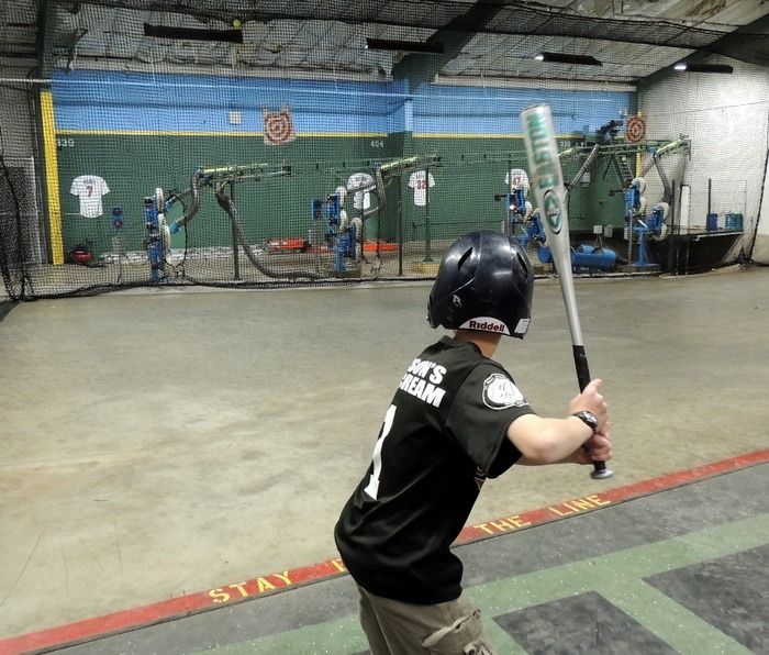 Boy practicing batting at Rice Arlington Batting Cage in Saint Paul, Minnesota