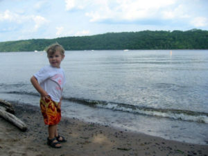 Small boy on the beach on the St. Croix River in Afton State Park, Hastings, Minnesota