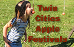 Girl playing an apple game trying to grab an apple from a string with only her mouth at a Twin Cities Apple Festivals