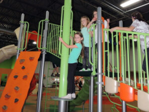 Kids climbing on indoor playground at Good Times Park in Eagan, Minnesota